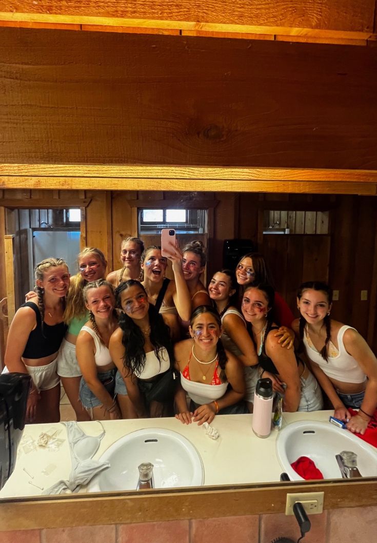 a group of women taking a selfie in the bathroom