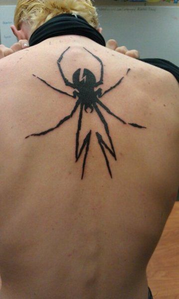 a man with a spider tattoo on his back