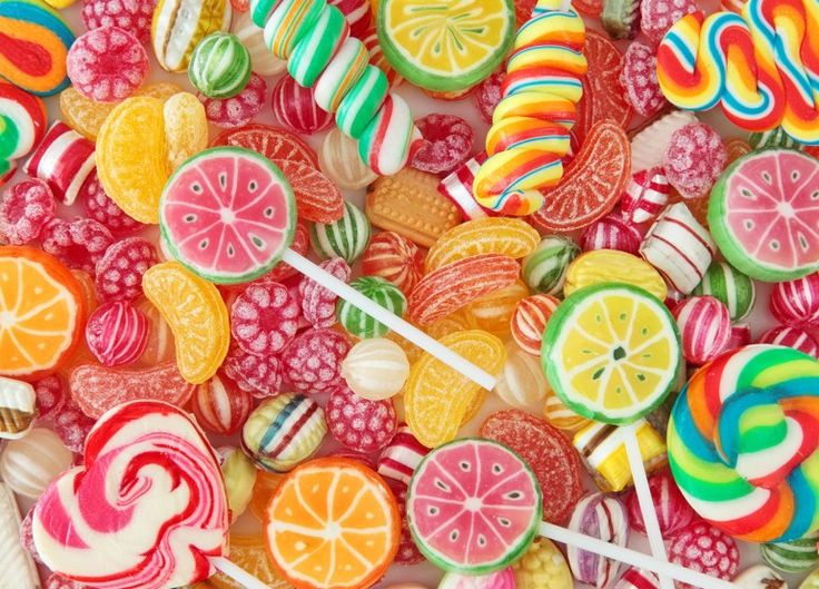 a pile of assorted candies and lollipops