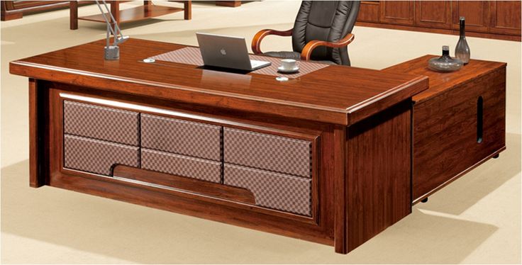 an office desk with a laptop on it