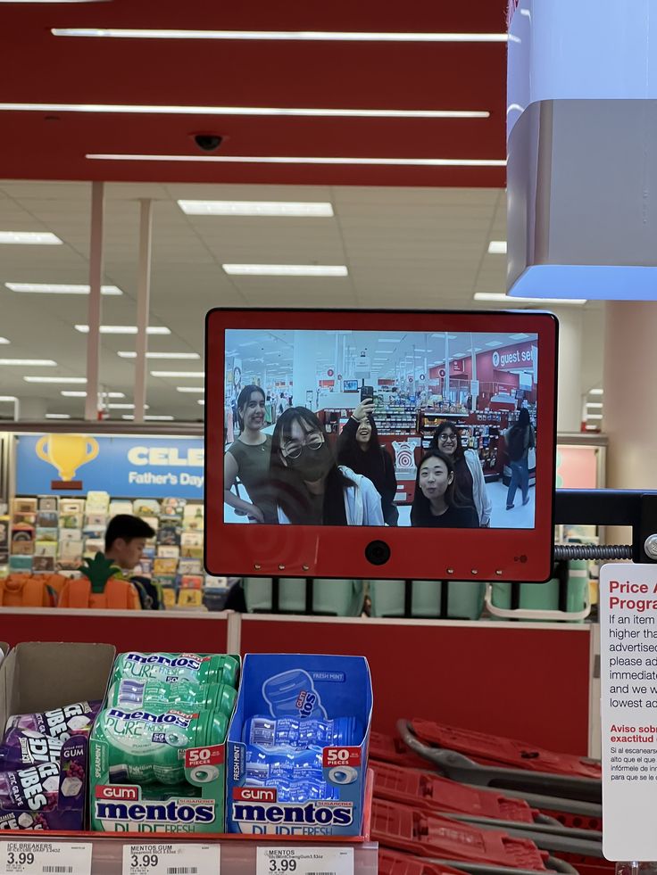 a television is on in the middle of a grocery store with other items for sale