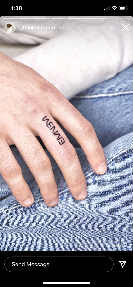 a person with a small tattoo on their finger