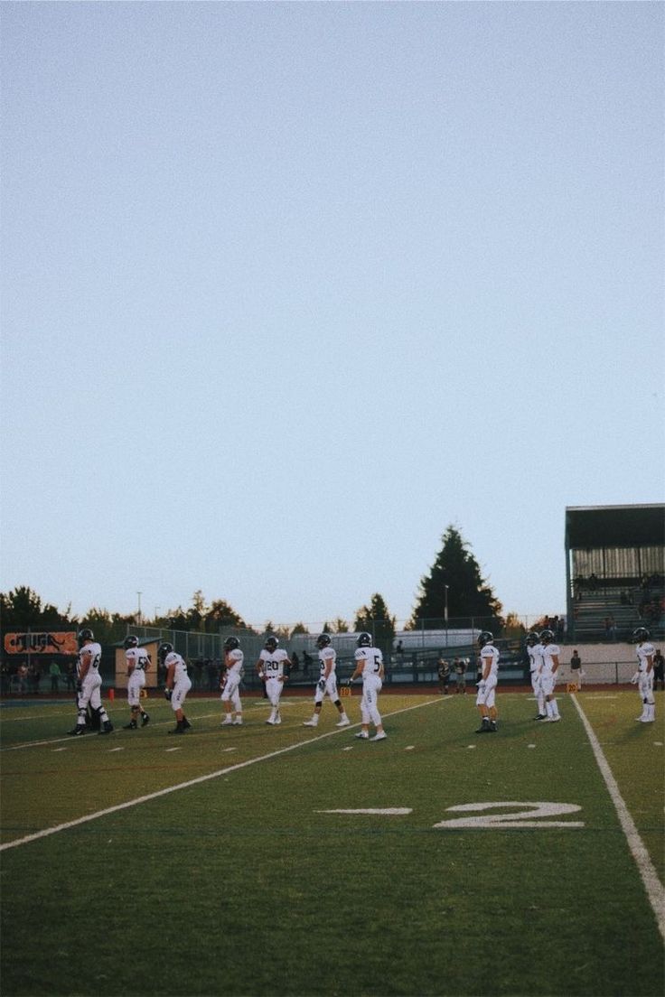 a group of people standing on top of a field