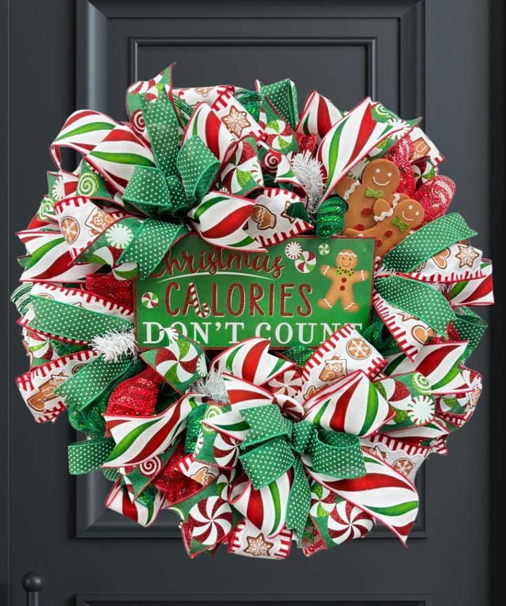 a christmas wreath with candy canes and an image of a gingerbread man on it