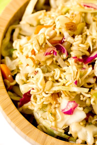 a wooden bowl filled with rice and vegetables