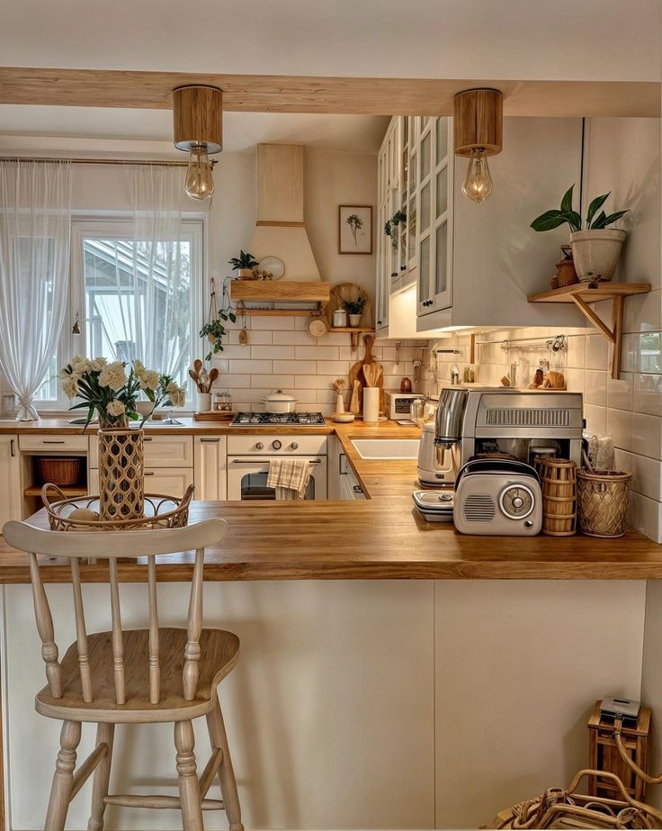 a kitchen filled with lots of appliances and counter top space next to a wooden bar