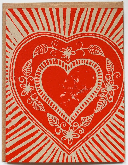 a red and white card with a heart on it