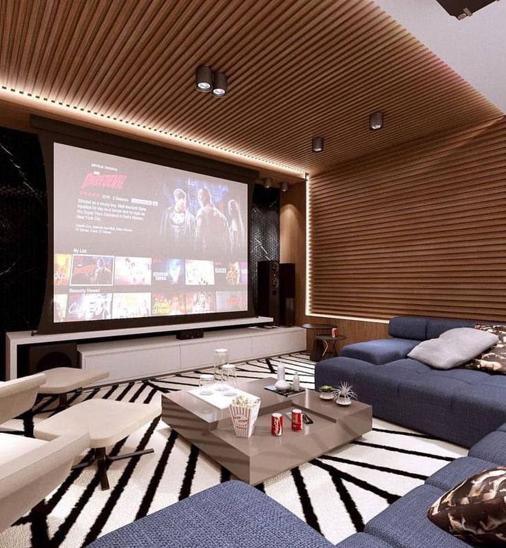 a living room filled with furniture and a flat screen tv mounted to the wall above it