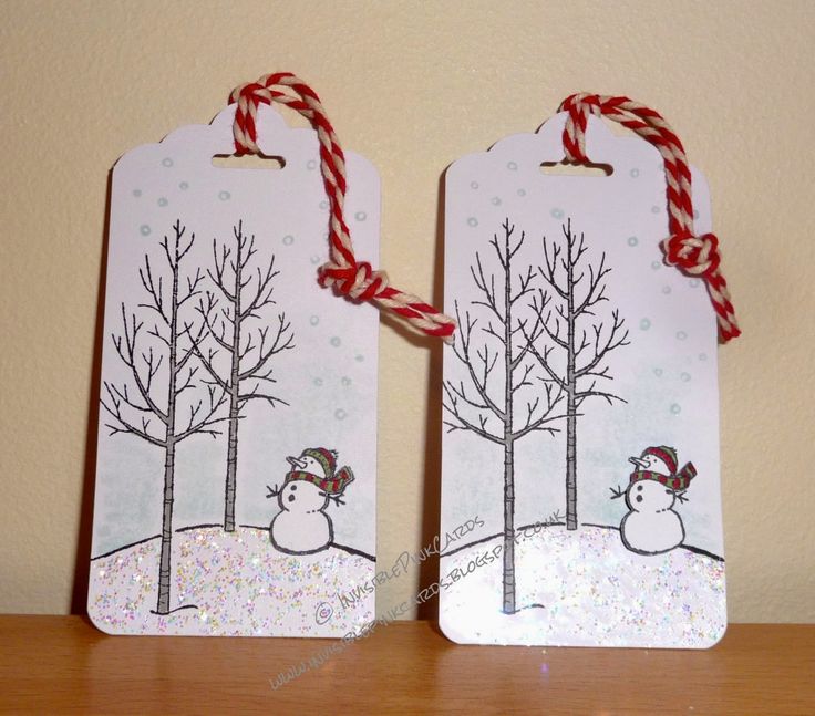 two tags with snowmen and trees on them