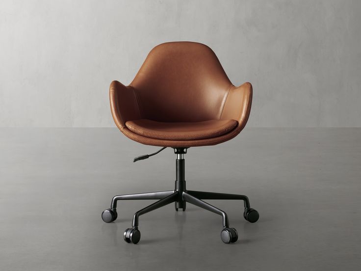 an office chair with wheels and a brown leather upholstered seat on a gray floor