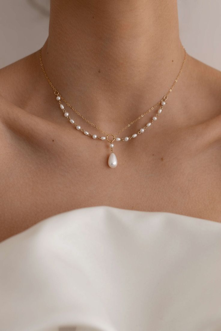 The Aurelia Pearl Necklace is handcrafted with 14k gold-filled chain and freshwater pearls to create a unique necklace embodying elegance and charm. Preorder 7-10 days send out. Packaged in an elegant plastic-free reusable jewelry box, this necklace makes the perfect gift or special treat for oneself. Note: This intricate necklace can tangle even with our utmost care in sending, please be gentle and patient to untangle and place in the right position after wearing. *14k gold-filled chain and com Luxury Delicate Pearl Necklace With Delicate Chain, Luxury Delicate Jewelry With Pearl Drop, Luxury Dainty Pearl Drop Jewelry, Cheap Elegant Pearl Necklace With Pearl Charm, Cheap Pearl Drop Necklace Gift, Cheap Adjustable Pearl Necklace For Wedding, Cheap Wedding Necklaces With Gold Beads, Cheap Dainty White Jewelry, Cheap Gold Wedding Necklaces