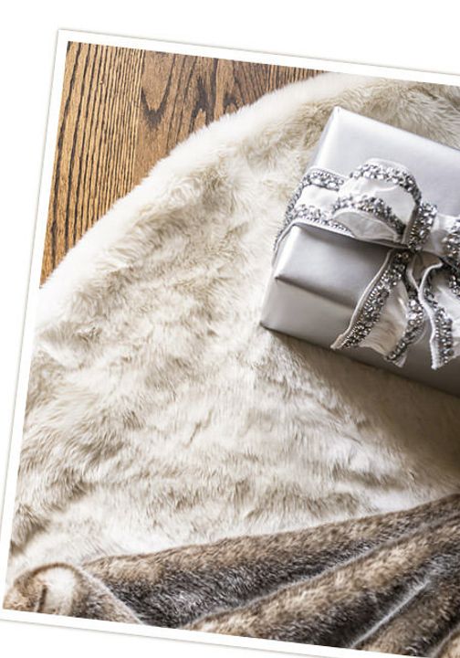 a wrapped present sitting on top of a fur covered floor