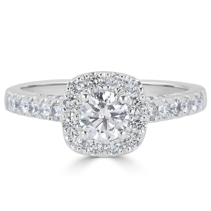 a white gold engagement ring with round diamonds on the band and an oval center stone