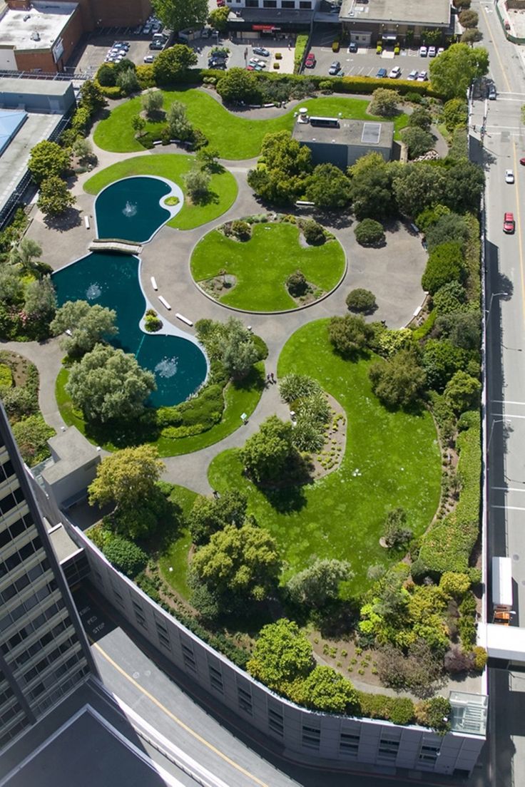 an aerial view of a green park in the middle of a city