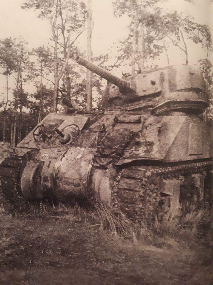 an old tank is sitting in the grass