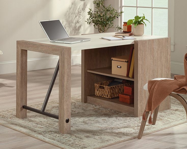 a laptop computer sitting on top of a wooden desk next to a chair and potted plant