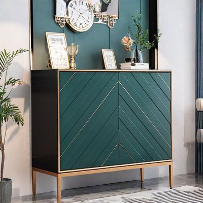 a green cabinet with gold trim on the front and sides, in a living room