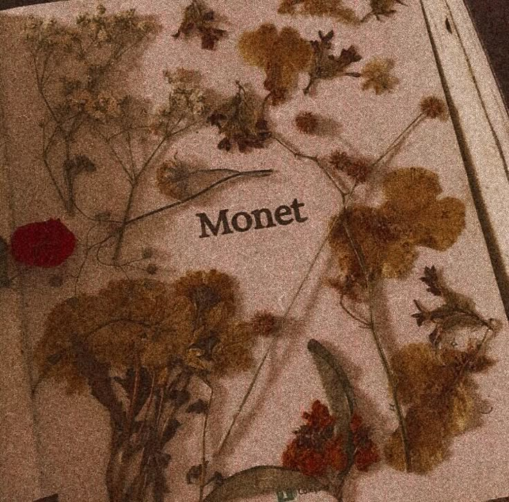 an open book with flowers and the word monet on it