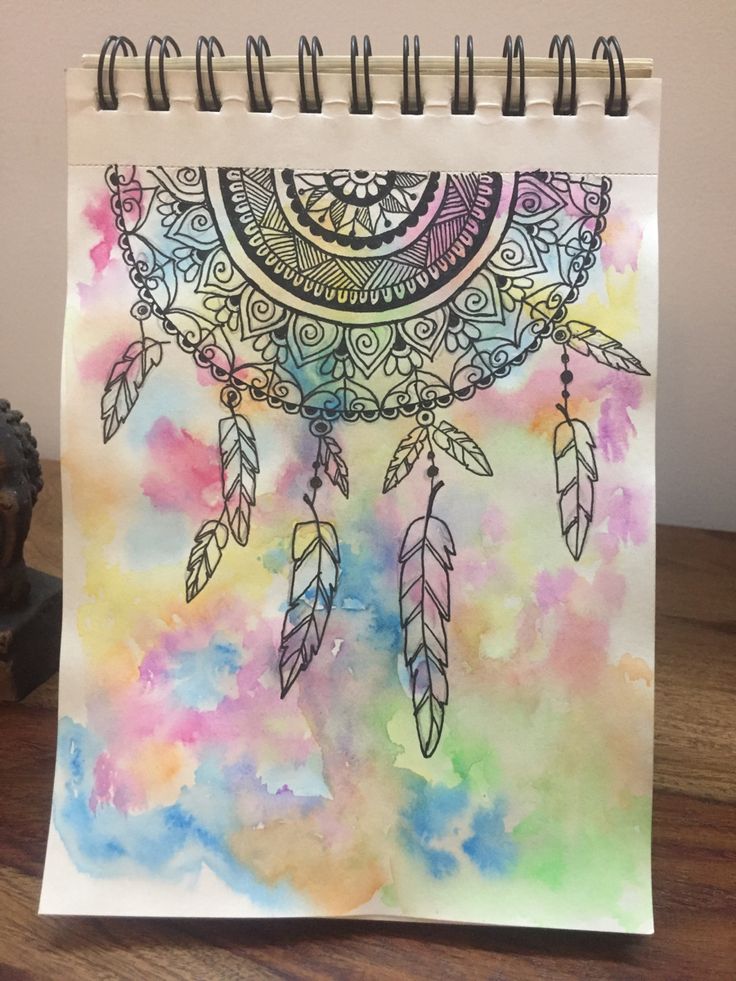 a spiral notebook with an image of a dream catcher