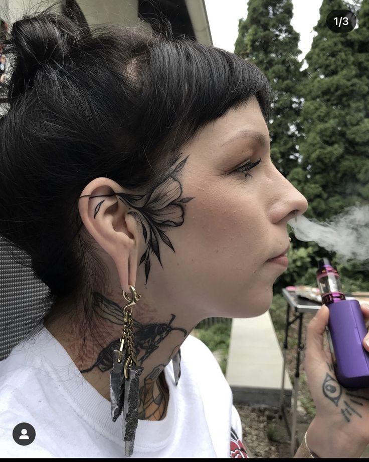 Sideburn Tattoos For Women, Face Tattoo Near Ear, Mandala Face Tattoo Design, Small Side Face Tattoo, Elegant Face Tattoo, Small Side Of Face Tattoo, Side Of Head Tattoo Women, Face Tatoos Woman, Blackwork Face Tattoo