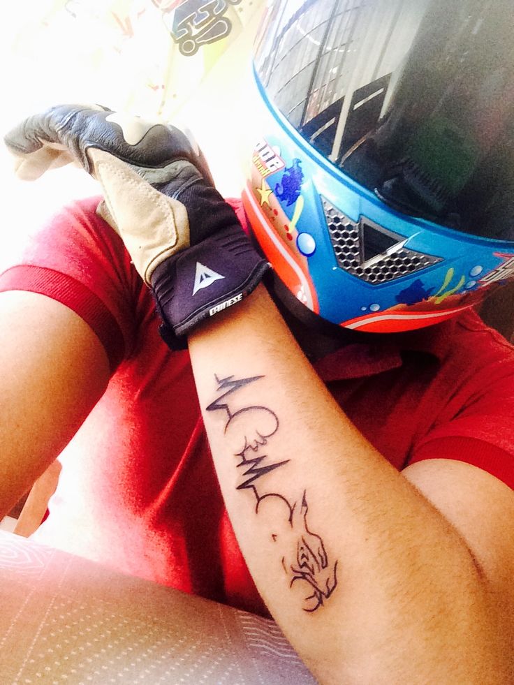 a person with a motorcycle helmet on their arm