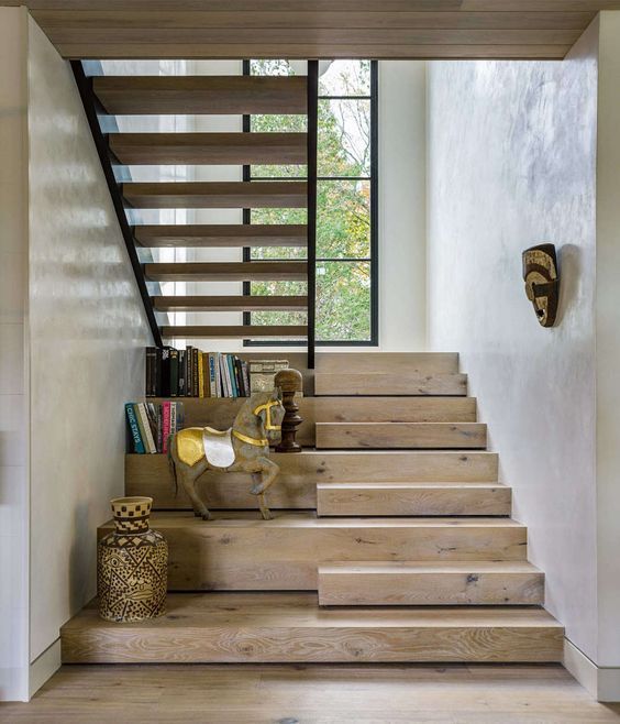 the stairs are made of wood and have metal handrails that lead up to the second floor