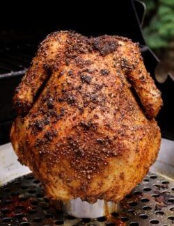 a whole chicken sitting on top of a grill