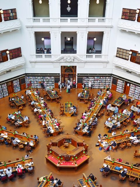 an overhead view of a library filled with lots of books and people sitting at tables