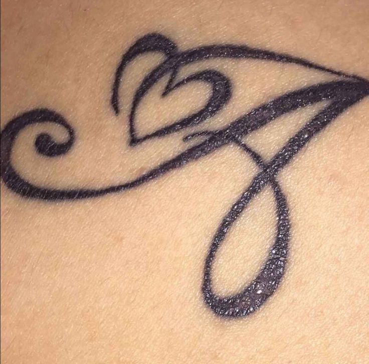 a close up of a tattoo on the back of a woman's shoulder