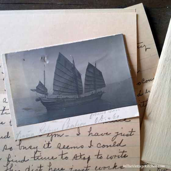 an old photo with writing on it next to some postcards and papers that have been placed together