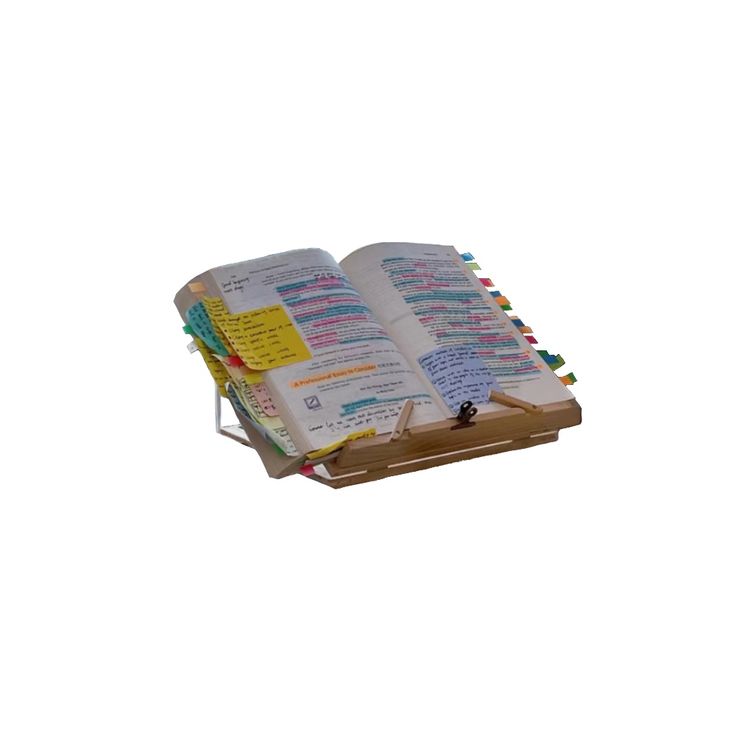 an open book with colorful notes on it sitting on a wooden stand against a white background