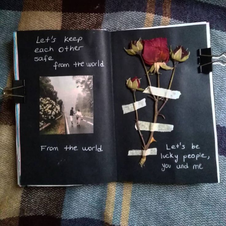 an open book with writing on the pages and a rose attached to it that says, let's keep each other safe from the world