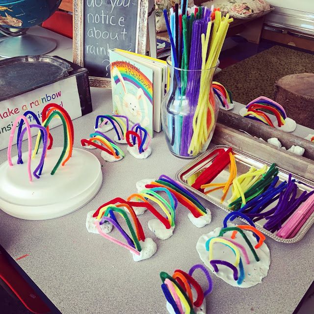 a table topped with lots of different colored straws next to a cup filled with candy