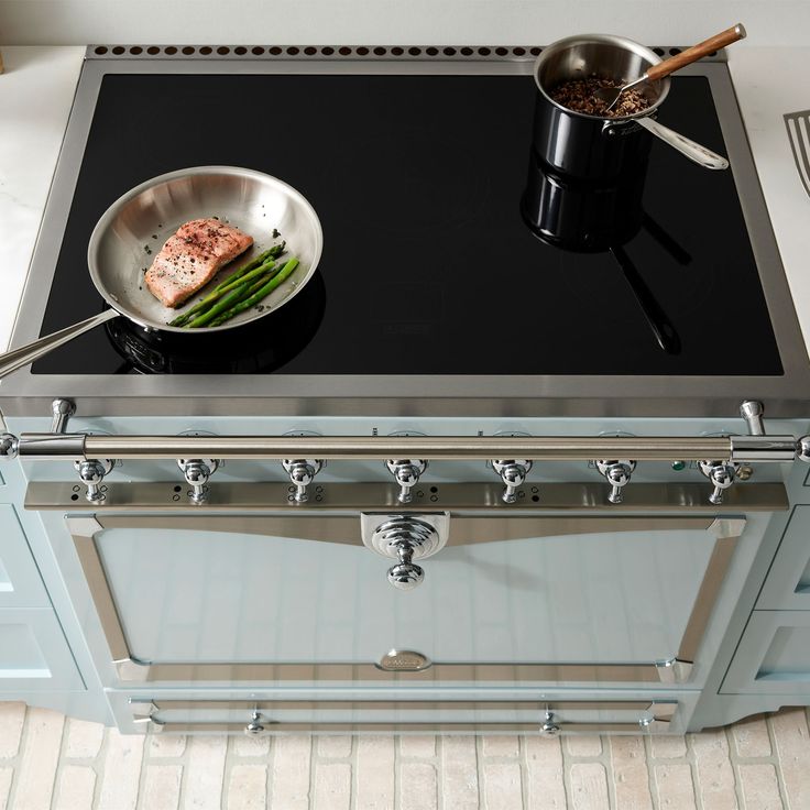 a pan with some food on it sitting on top of a stove in a kitchen