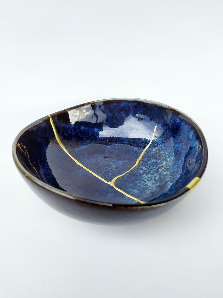 a blue bowl with gold lines on it