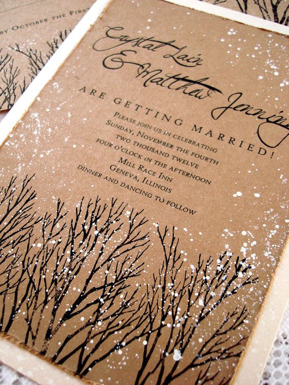 two brown and white wedding cards with snow on them are sitting on a tablecloth