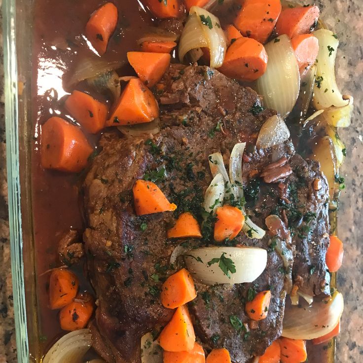 meat, onions and carrots in a casserole dish