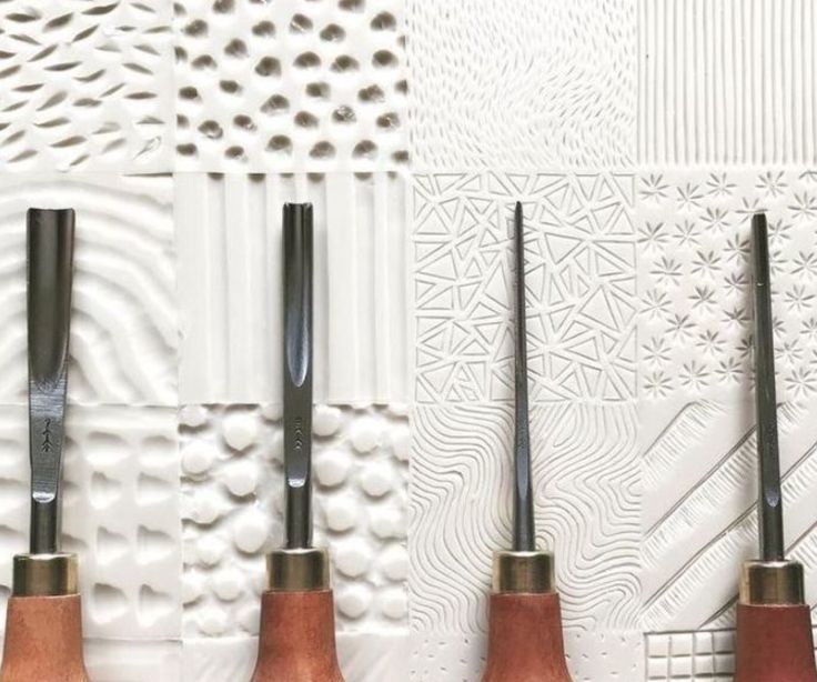 four different types of carving tools lined up on a wall