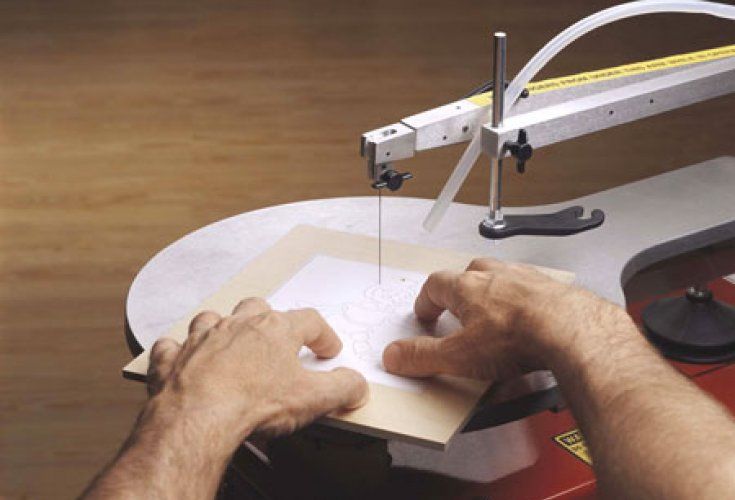 a man is using a sewing machine to sew something on a piece of paper