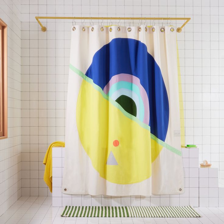 a shower curtain with an image of a yellow bird on it's side in a bathroom