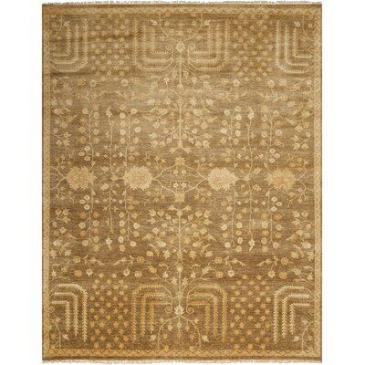 a brown and beige rug with an intricate design