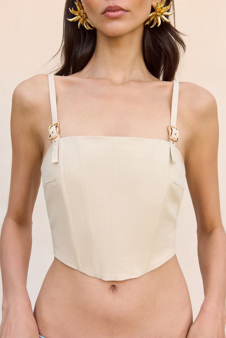 A cotton twill cropped corset top with fixed front buckles and open back. — Cropped length — Corset top — Fixed front buckles — Adjustable back buckles — Side zipper Cropped Corset Top, Cropped Corset, Platform Flats, Evening Sandals, Beach Tops, Icon Collection, Knit Set, Winter White, Cozy Fall