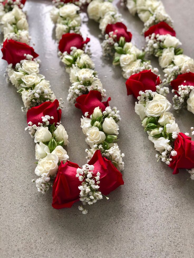 red and white flowers arranged in the shape of letters