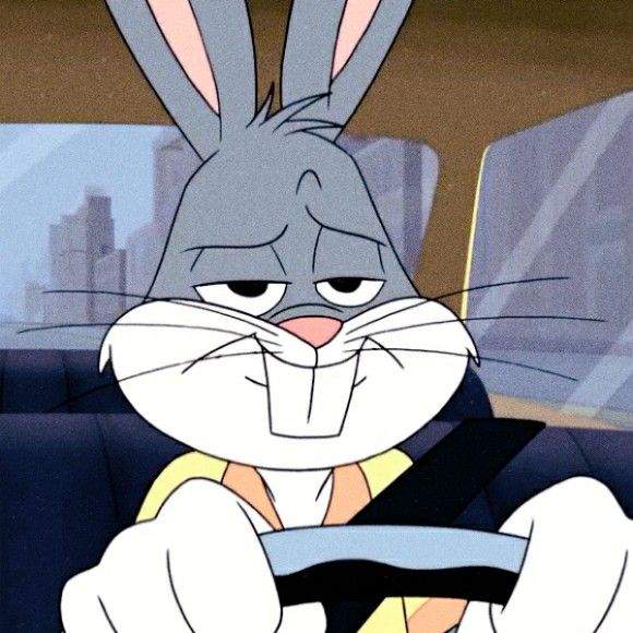 an animated rabbit driving a car with the steering wheel in his hand and looking at the camera