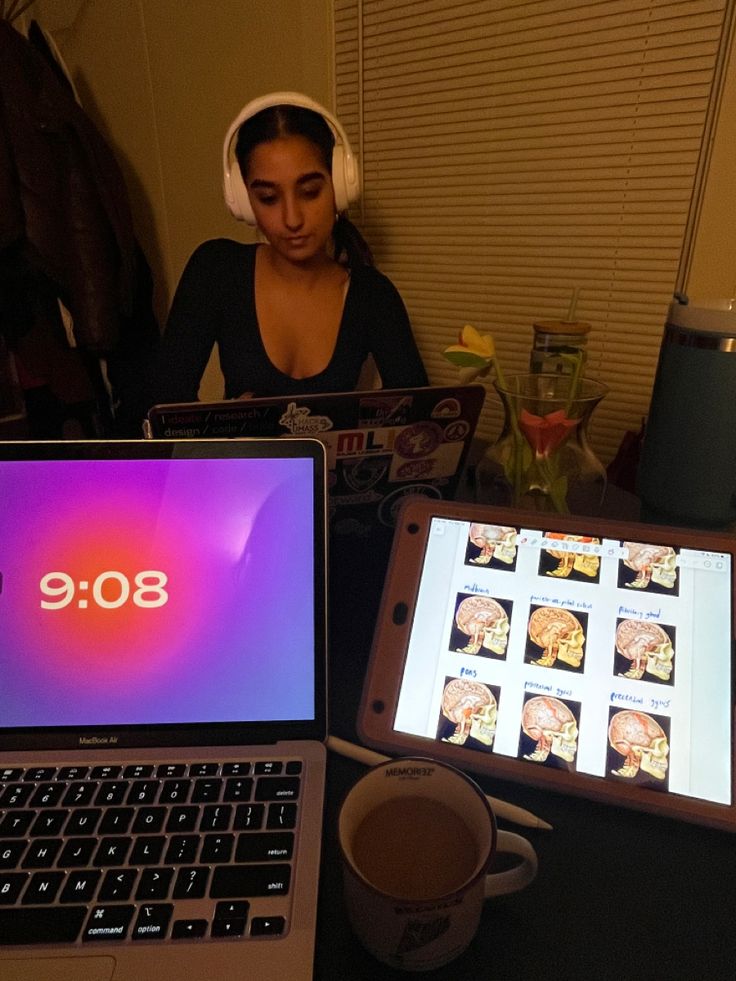 two laptops sitting next to each other on a table