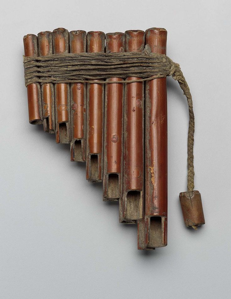 an old wooden instrument with strings attached to it