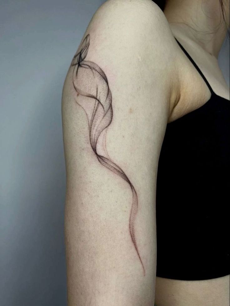 a woman with a tattoo on her arm