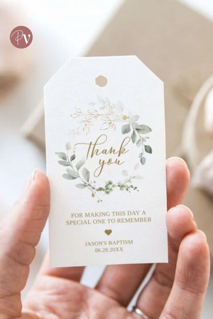 a person holding up a white thank card