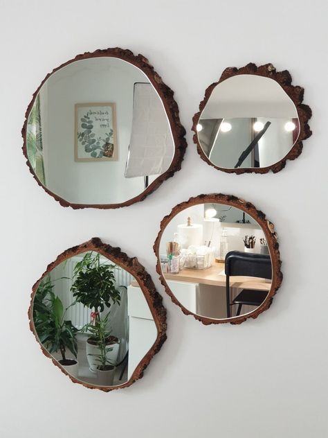 three mirrors hanging on the wall above a table