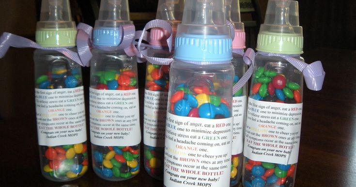 several baby bottles with candy in them sitting on a table